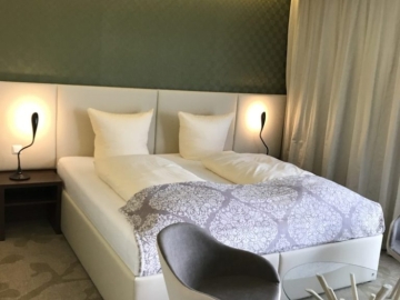 Manželská postel s designovým čelem z materiálu kůže.  
